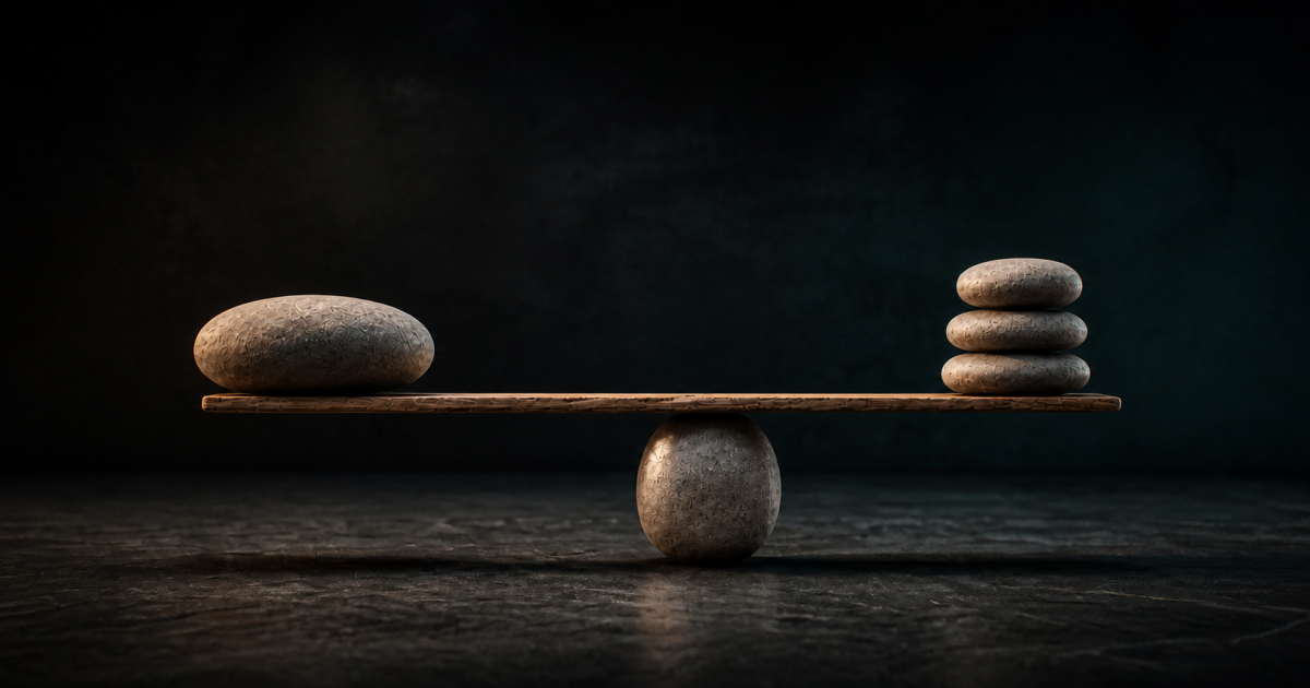 A level wooden beam and river stones photographed against a dark teal studio backdrop