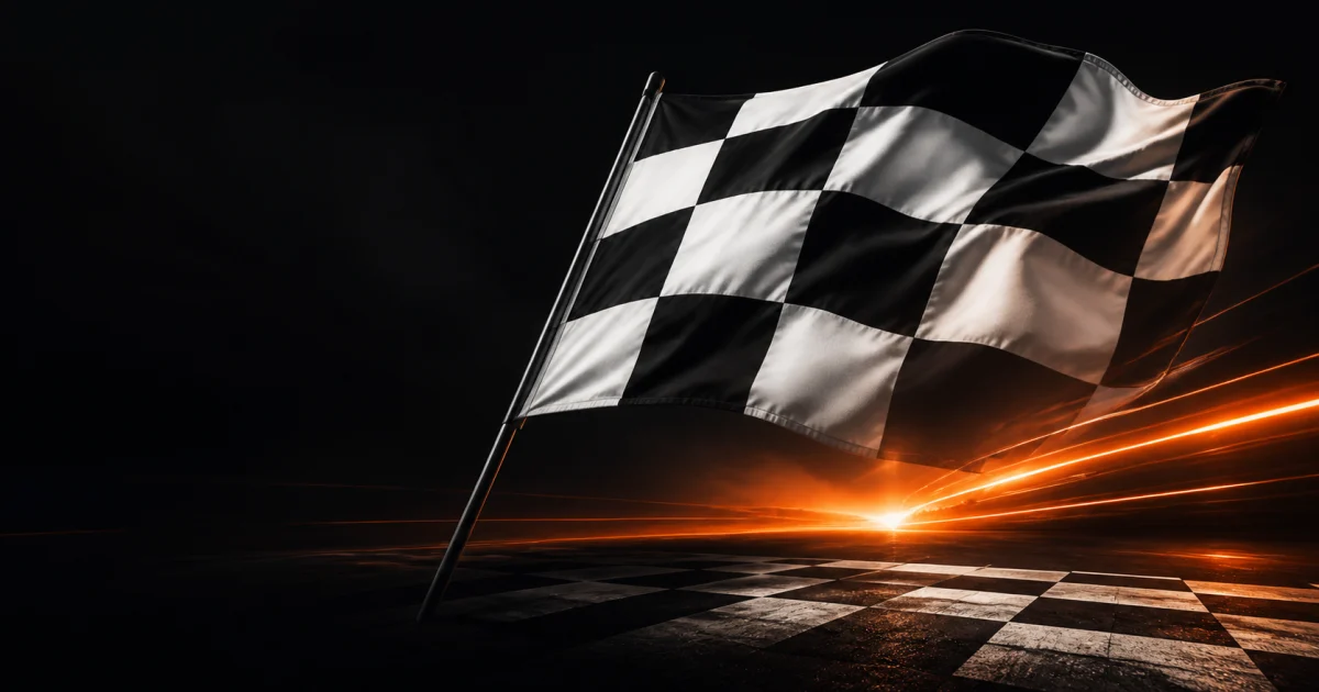 A sweeping black-and-white checkered flag above a finish line with vivid orange light streaks